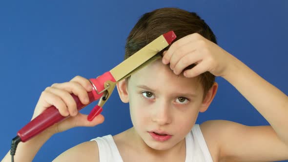 Caucasian boy 8 years old washing his face, drying his hair with a curling iron and singing in the b