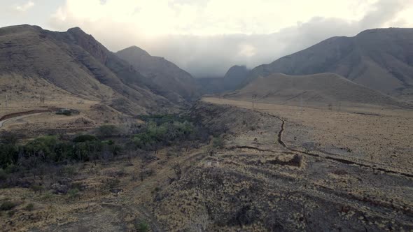 Drone shot revealing the stunning nature of the land on the Hawaiian Islands. Small fertile valleys