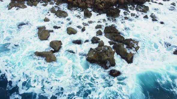 Colourful Waters of the Ocean Swirl Around the Rocky and Scenic Coastline