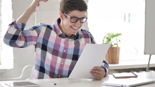 Young Man Celebrating Success of Contract