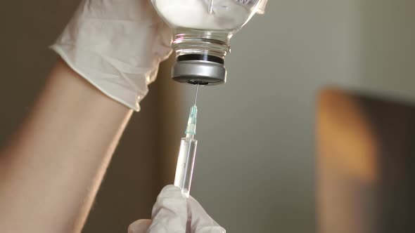 Closeup of the Hands of Nurses with a Syringe