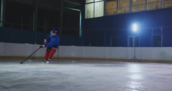 Hockey Forward Carrying a Puck, Skating Past an Opposing Defenseman and Taking a Slap Shot