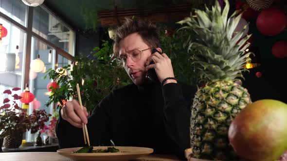 Guy Talking on the Phone at the Dinner Table