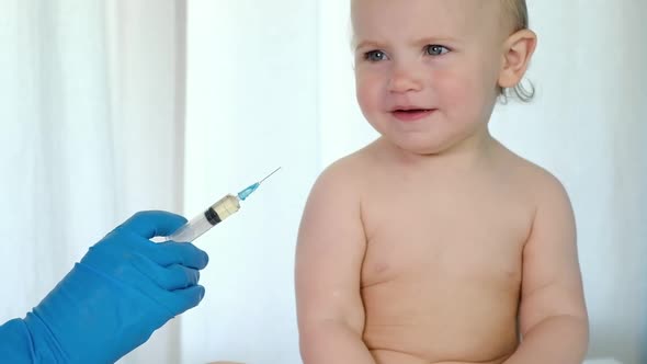 Doctor Vaccinating Baby in Clinic