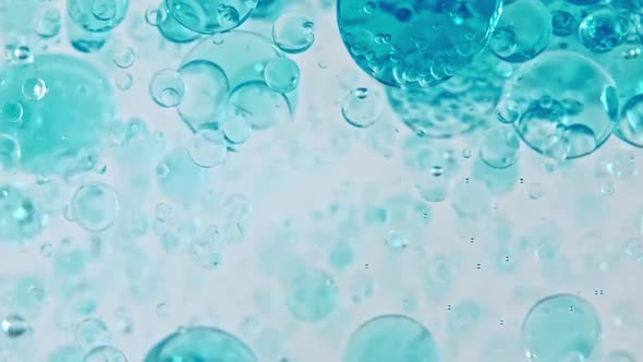 Macro Shot of Various Air Bubbles in Water Rising Up on Light White Background