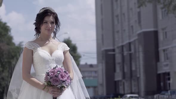 Slow Motion Young Pretty Woman Holds Purple Wedding Bouquet
