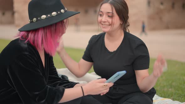 Caucasian Friends on Public Park Chatting While Using Smartphone Slowmotion