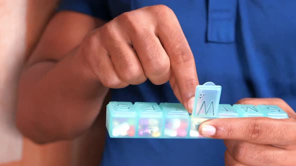 Close Up of Man Hand Taking Pills From Pill Box 