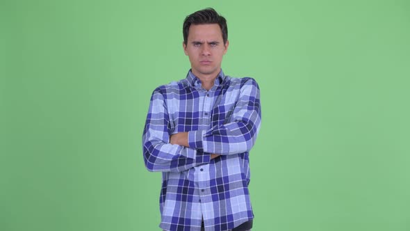 Angry Young Hipster Man with Arms Crossed