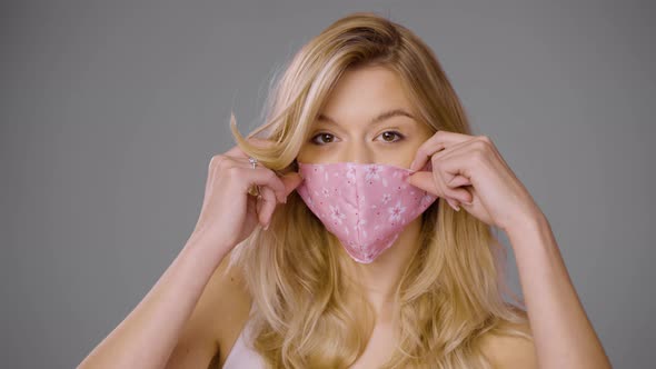 Woman Adjusting Mask and Looking at Camera