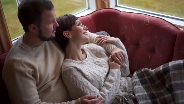 Romantic Couple Is Lying on the Sofa at Home.