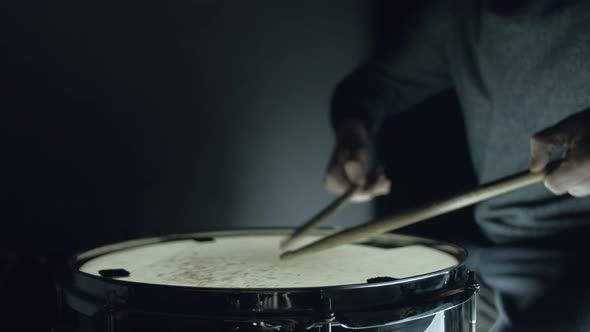 Drummer Plays with Sticks on a Snare Drum