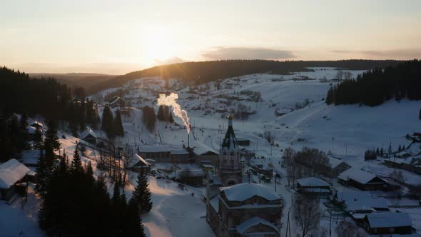 Aerial View of the Village at Sunset in Winter with Bright Sun