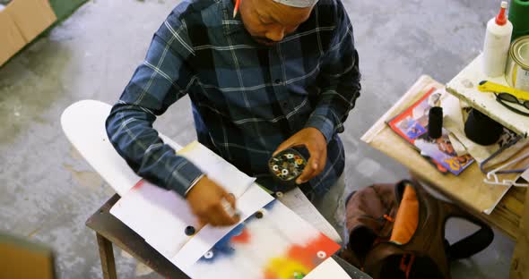 Man using spray painting on a paper 