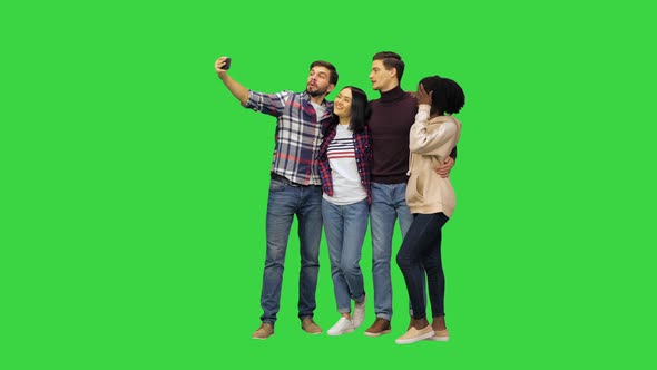 A Group of Cheerful Students Taking a Selfie on a Green Screen Chroma Key