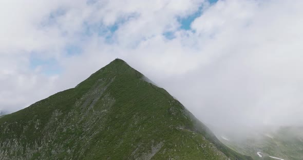 aerial view of moldoveanu peak in clouds with tourists