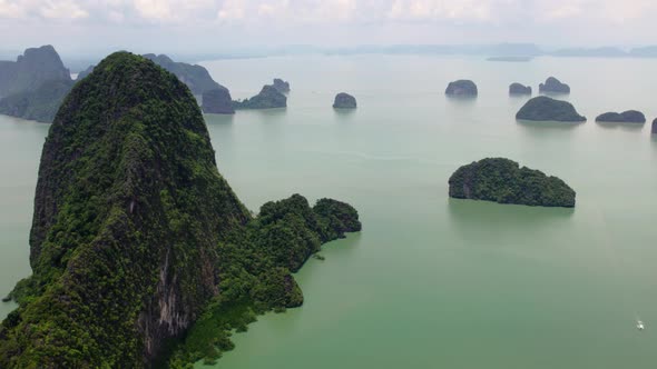 Fly sideways over green mountain at sea, Phang Nga bay, Thailand