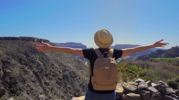 Young Foreign Female Tourist Enjoying the View of Omani Mountains at Jebel Akhdar Gorge in Al Hajar