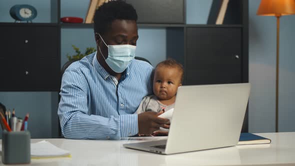 Father in Mask Measuring Temperature To Cute Sick Baby Consulting Doctor Online