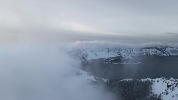 Drone video of volcanic caldera lake with clouds, Crater Lake, Oregon, USA