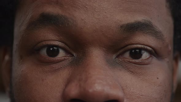 Extreme Closeup of a Surprised Africanamerican Man's Eyes Recieving Good News
