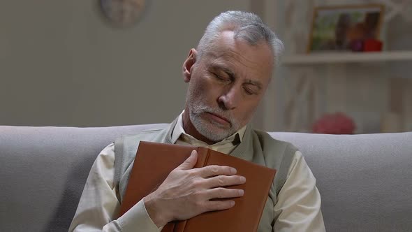 Elderly Man Sleeping on Sofa During Reading