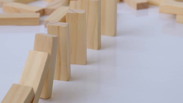 Domino Effect Row of Wooden Domino Falling Down on White Background