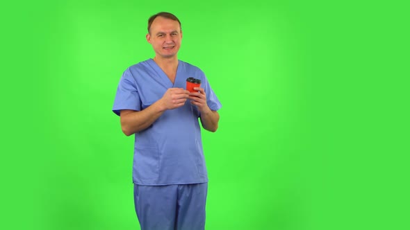 Medical Man Enjoying Coffee on Green Screen.