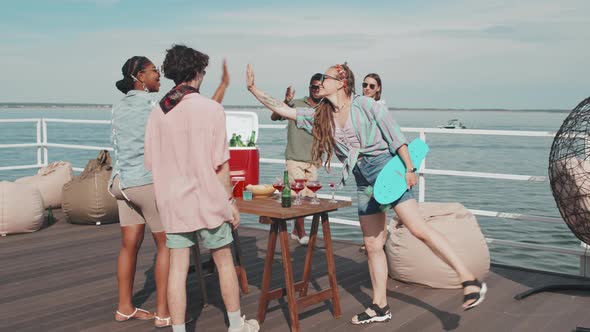 Skater Girl Greeting Friends on Pier