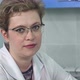 Female Doctor Wearing Glasses Sitting at Her Desk Looking Directly at the Camera - VideoHive Item for Sale
