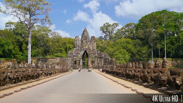 4K Bayon Angkor Thom Entrance Gate as Tourists Walk and Ride by