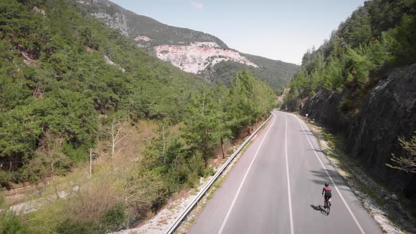 Cyclist riding bicycle inmountains