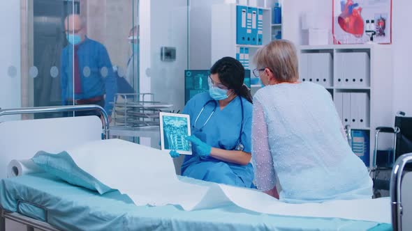 Nurse in Mask Explaining Diagnostic