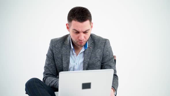 Grieved businessman looking into the laptop