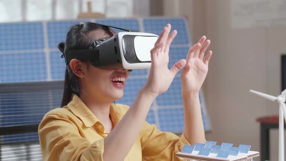 Woman Working With A Model Of Small House Roof Solar Panel Wearing Vr And Showing Touching Gesture