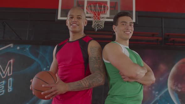 Portrait of Two Smiling Basketball Players Indoors