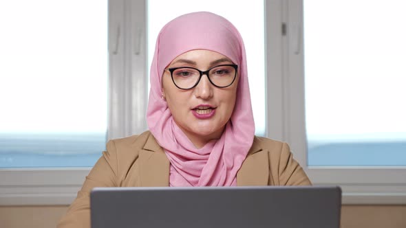 Young Muslim Woman Talking By Video Call on Laptop