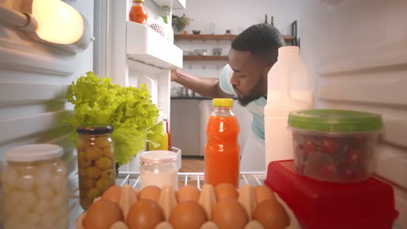 African Young Guy Looking for Meal To Eat in Fridge