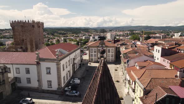 Aerial panning shot Chaves Old town, City hall square, Church and Castle Tower - Portugal