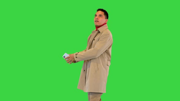 Handsome Young Man Taking a Picture with Mobile Phone While Walking on a Green Screen Chroma Key