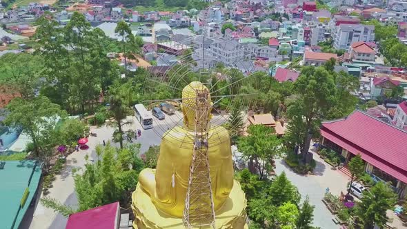 Camera Flies Behind Golden Buddha Statue Back with Nimbus