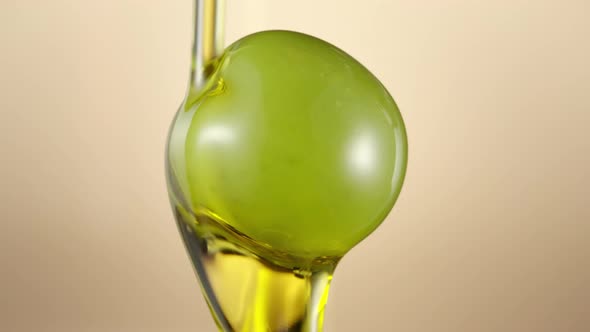 Green olive covered with oil on nude yellow 