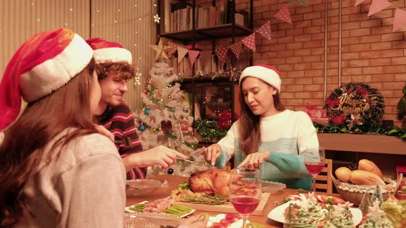 Friends enjoy eating special diner at Christmas festival parties.