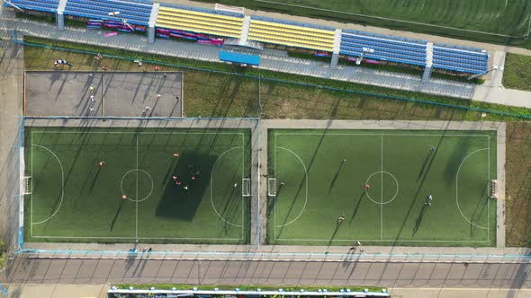 Top View of a Sports Football Field with Players Playing Football