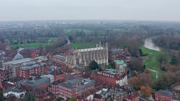 Rotating aerial drone shot of Eton college Chapel on a cloudy day