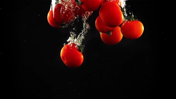 Tomatoes Fall Under the Water with Air Bubbles