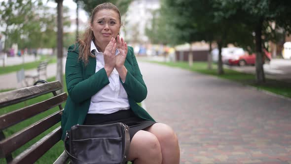 Thrilled Excited Plussize Woman with Cash Sitting on Bench in City Outdoors