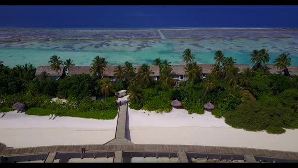 Aerial above scenery of exotic coastline beach vacation by blue ocean and white sand background of a