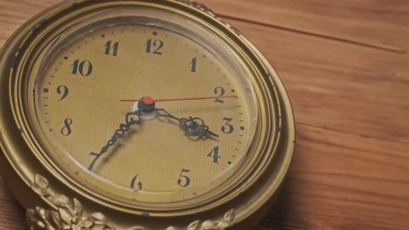 Vintage Wall Clock with Moving Second Hand on Wooden Background