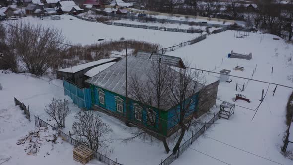 Old Wooden Houses in the Russian Village Covered with Snow